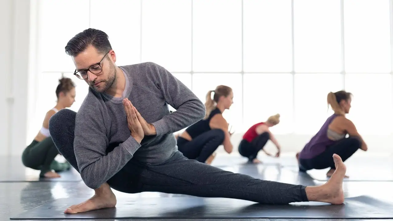 A diverse group of people in a Vinyasa Flow class